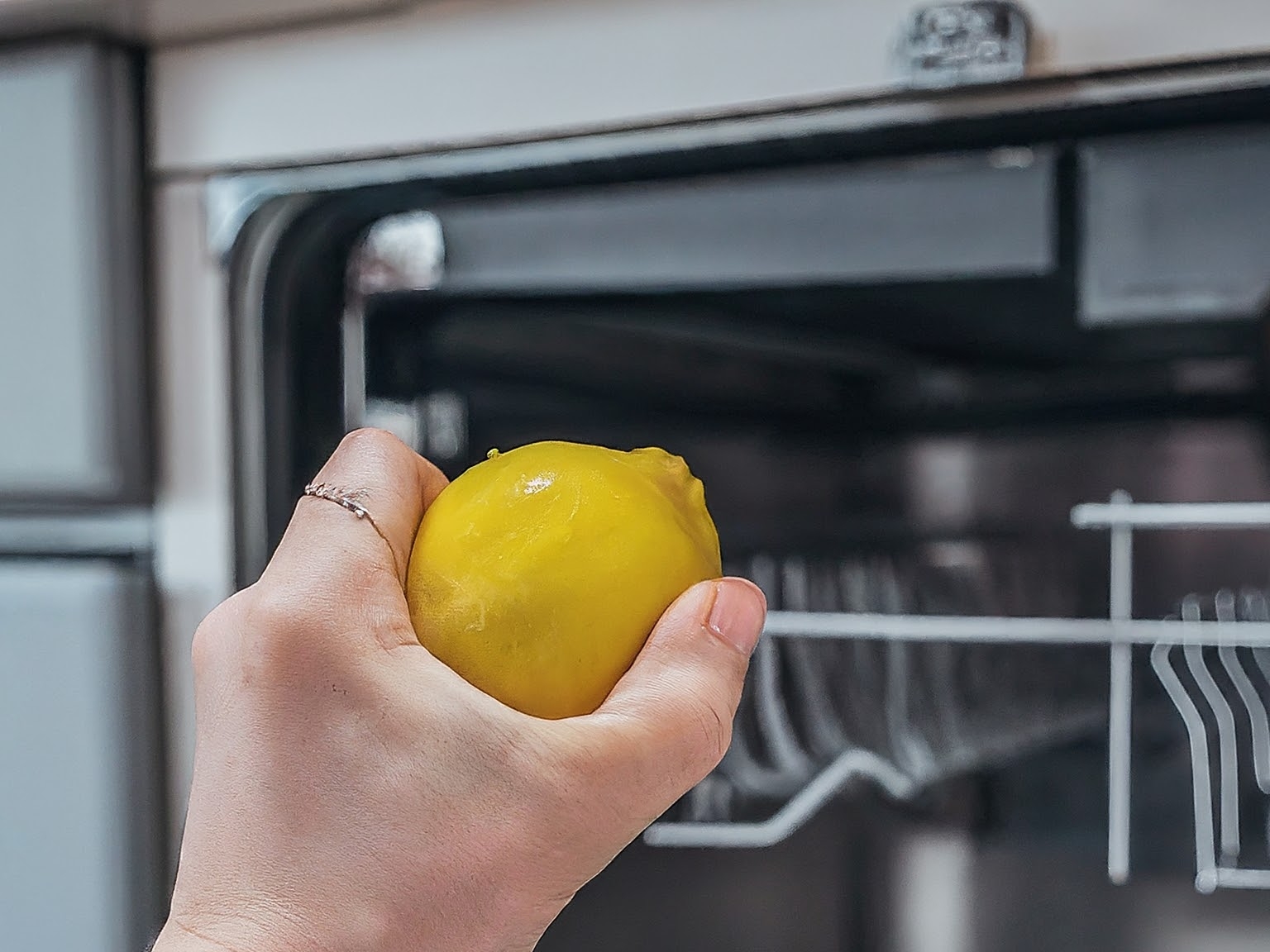 Stainless Steel Kitchen Appliance Cleaning with Half Cut Lemon